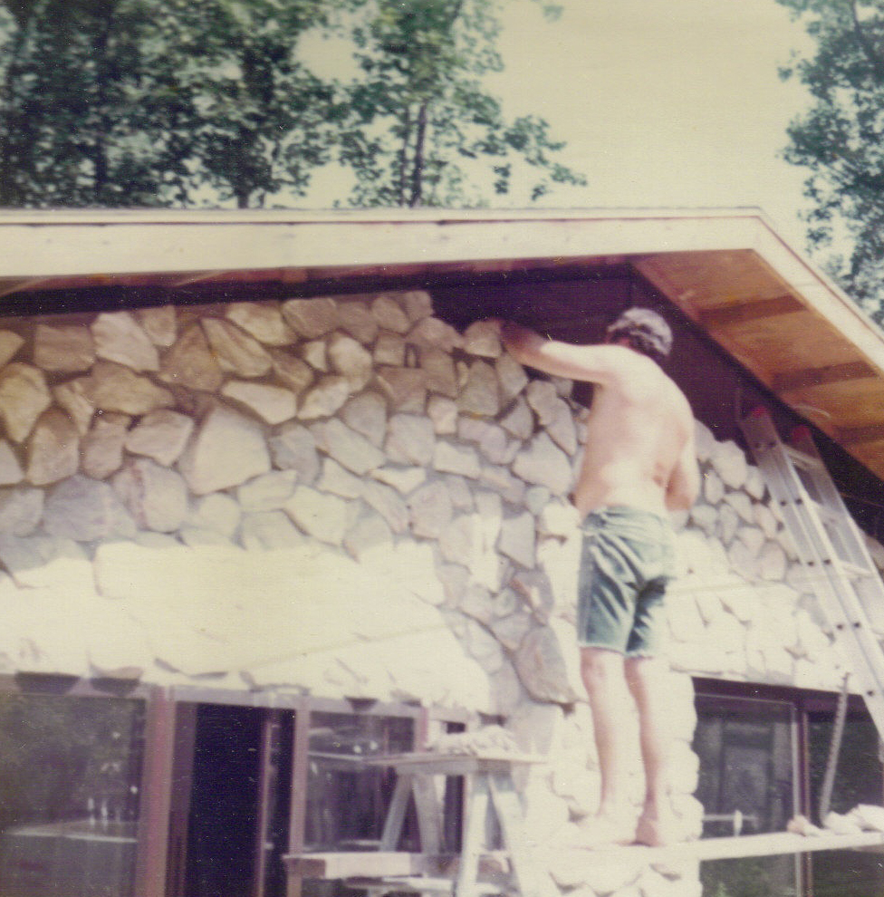 Dad laying the white Georgia marble stone on back of the house